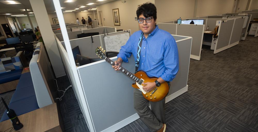 Diego Salas Polar in his office with his guitar.